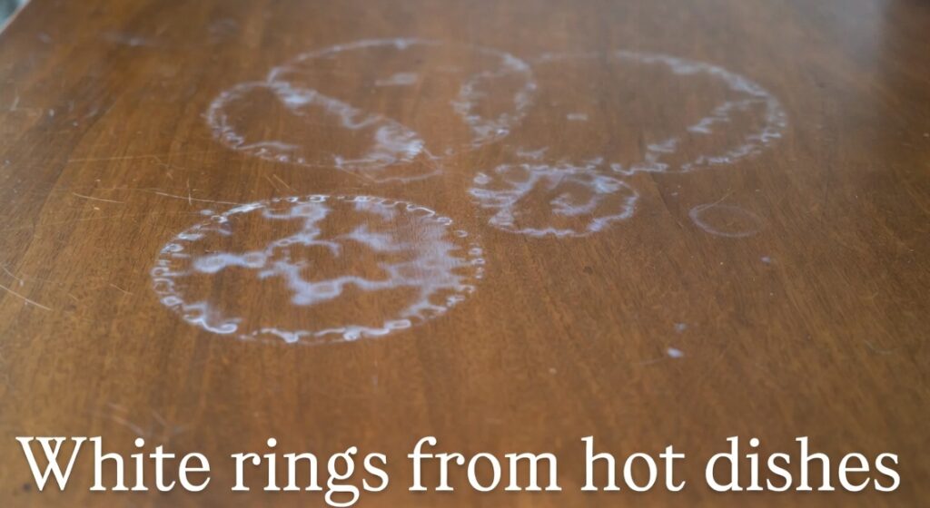 Heat marks and white rings on wood dining table surface